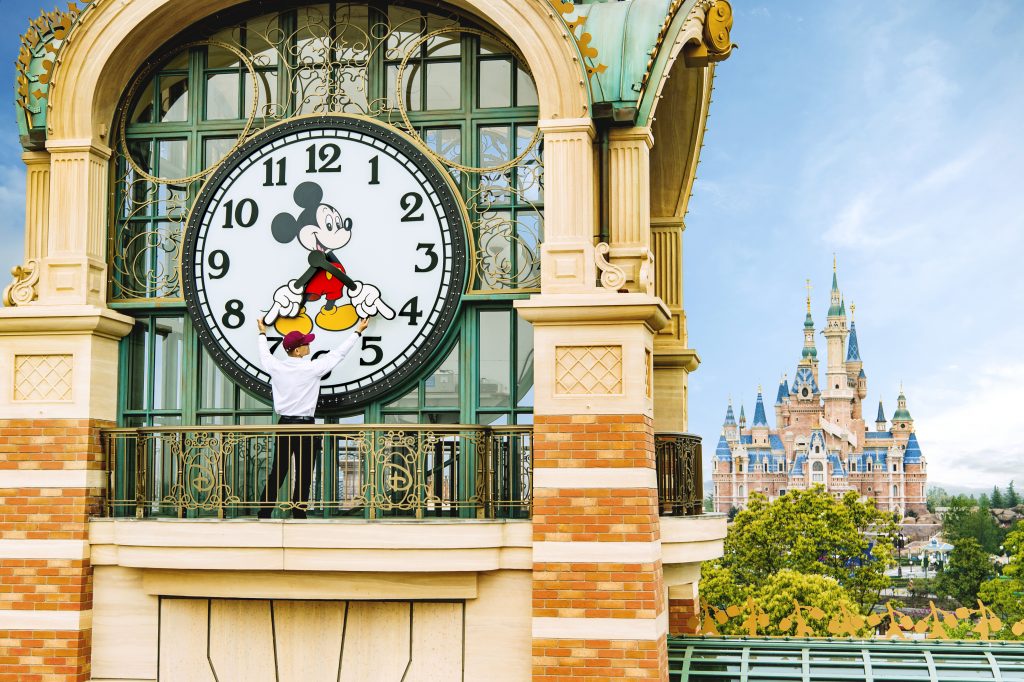 ALMOST TIME - A Shanghai Disneyland cast member prepares the theme park's iconic "Mickey Avenue" clock in advance of the Grand Opening of Shanghai Disney Resort on June 16, 2016 with the spectacular backdrop of the world's largest Disney castle, The Enchanted Storybook Castle. Shanghai Disney Resort is a world-class family entertainment destination, imagined and created especially for the people of China. Ideal for multiple-day visits, the resort consists of Shanghai Disneyland, a theme park with magical experiences for guests of all ages; two richly themed hotels; Disneytown, an international shopping, dining and entertainment district; and Wishing Star Park, a recreational area with peaceful gardens and a glittering lake. The resort's hotels are the elegant, 420- room Shanghai Disneyland Hotel and the playful, 800-room Toy Story Hotel. Shanghai Disney Resort is a joint venture between The Walt Disney Company and Shanghai Shendi Group comprised of two owner companies (Shanghai International Theme Park Company Limited and Shanghai International Theme Park Associated Facilities Company Limited) and a management company (Shanghai International Theme Park and Resort Management Company Limited). (Matt Stroshane, photographer)