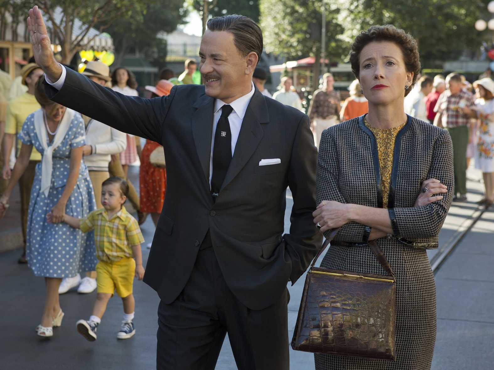 Walt Disney (Tom Hanks) and P.L. Travers (Emma Thompson) walk through Disneyland